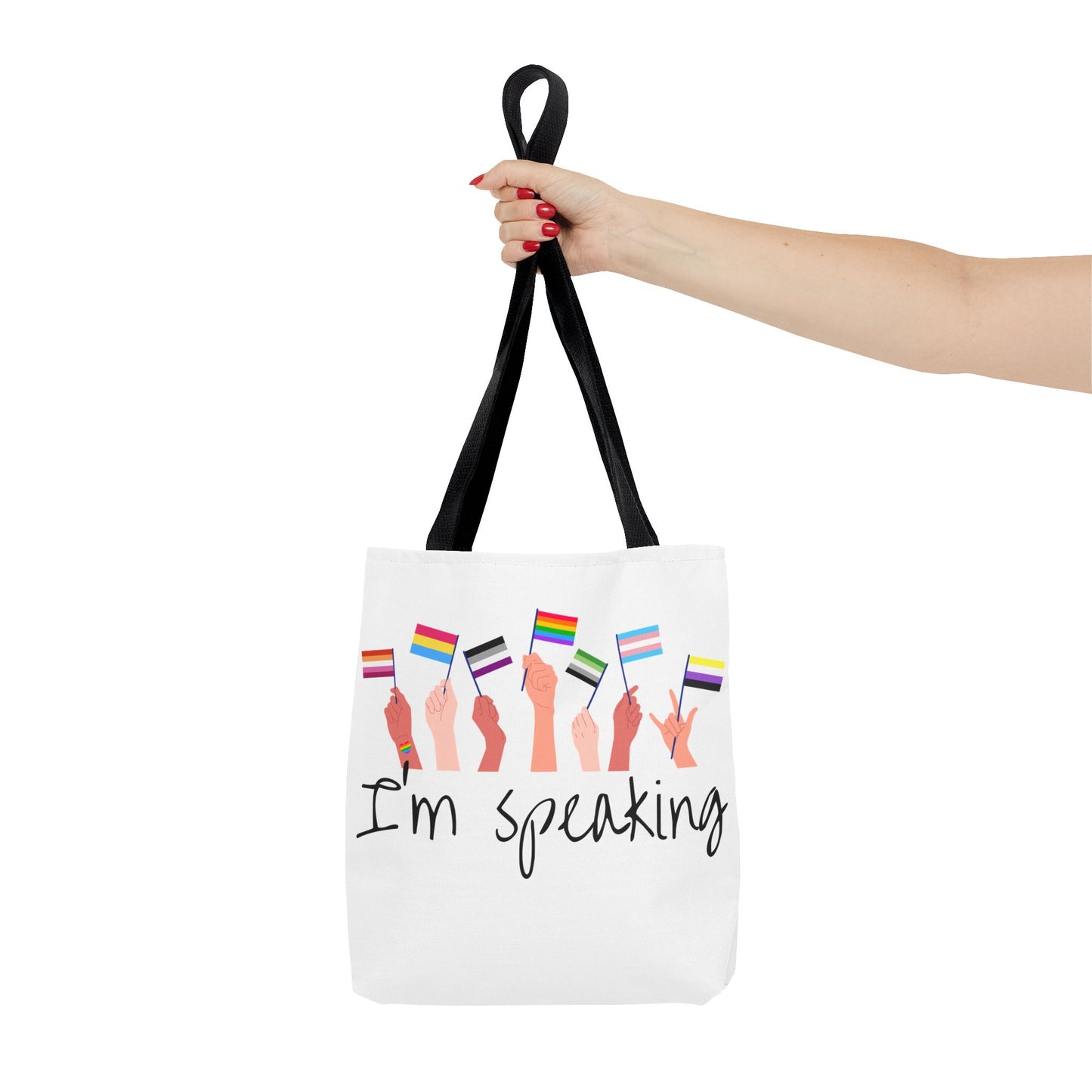 Mockup of a hand holding a "I’m Speaking Gay Pride Tote – Designed by Queer Energy"