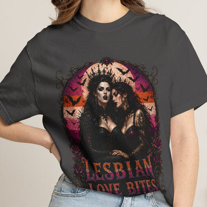 A woman wearing a dark charcoal gray graphic t-shirt with a gothic lesbian love bitte design, paired with light-wash denim shorts, in a cozy indoor setting.