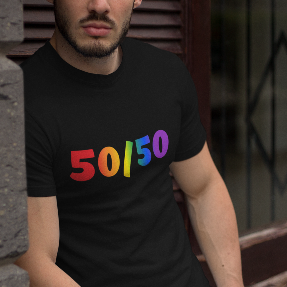 A mockup of a gay man wearing a black Gay Pride tee that says 50/50 in rainbow colors for bisexuals| Pride t-shirt designed by Queer Energy  