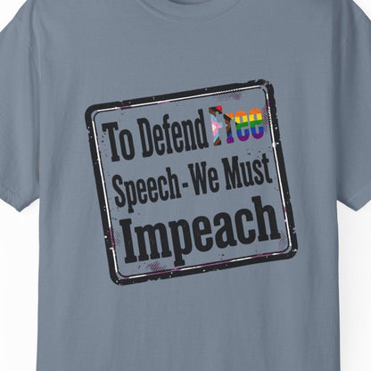 Blue short-sleeve crewneck t-shirt featuring a distressed black rectangular graphic with the text 'To Defend Free Speech - We Must Impeach' and the word 'Free' filled with a LGBTQ rainbow pattern.