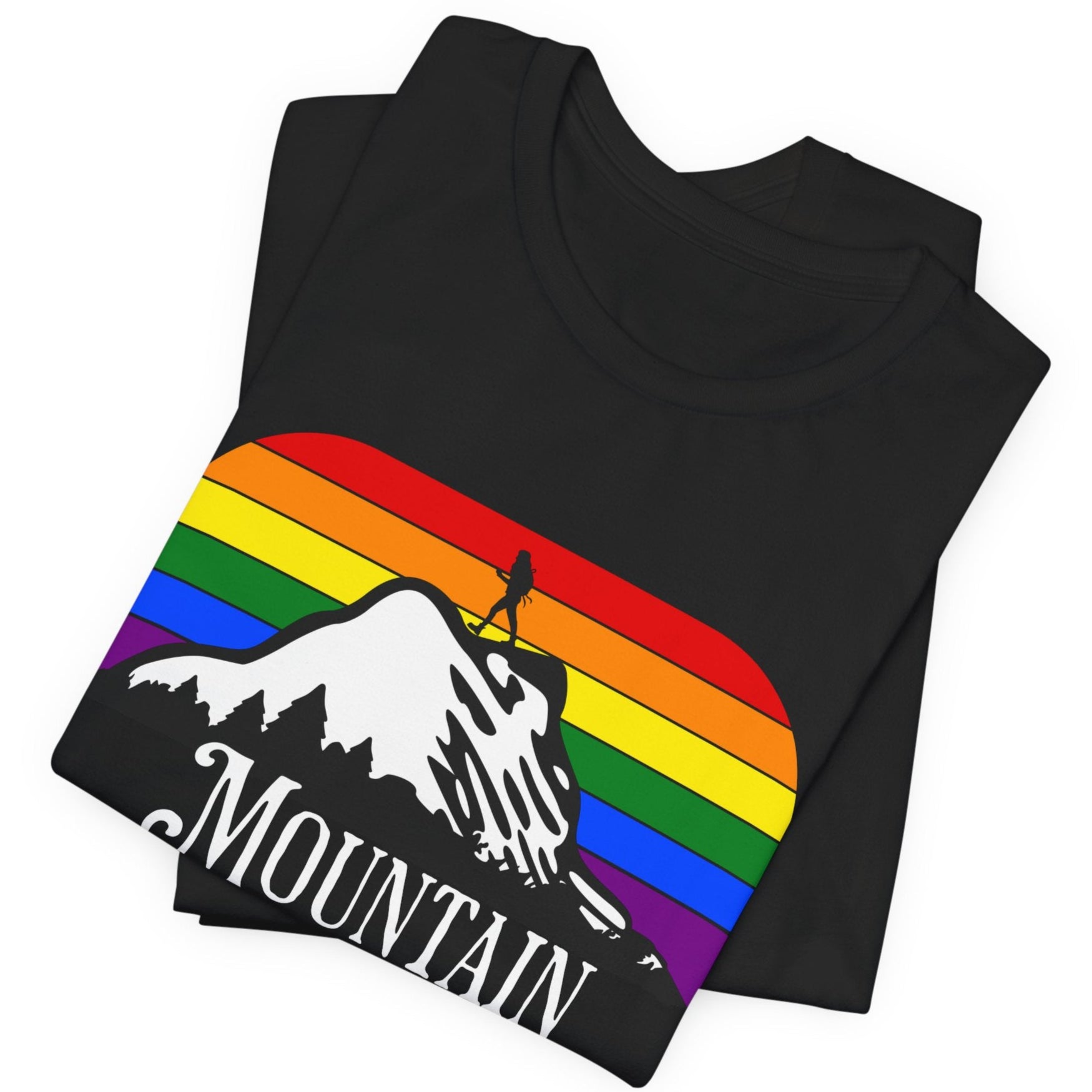 A mockup of a folded black Lesbian Pride tee that says Mountain Momma| LGBT Pride tee in rainbow background designed by Queer Energy 