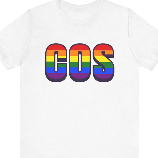 White T-shirt that says COS | Colorado Springs Airport| Pride tee with the text in Pride rainbow colors
