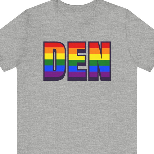 Gray T-shirt that says DEN | Denver International Airport| Pride tee with the text in Pride rainbow colors