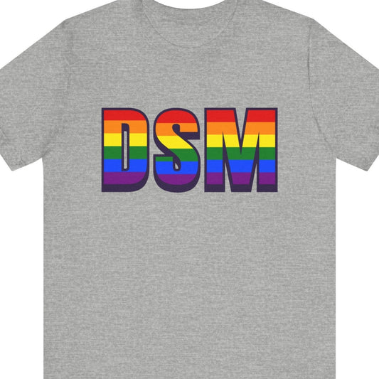 Gray T-shirt that says DSM | Des Moines International Airport| Pride tee with the text in Pride rainbow colors