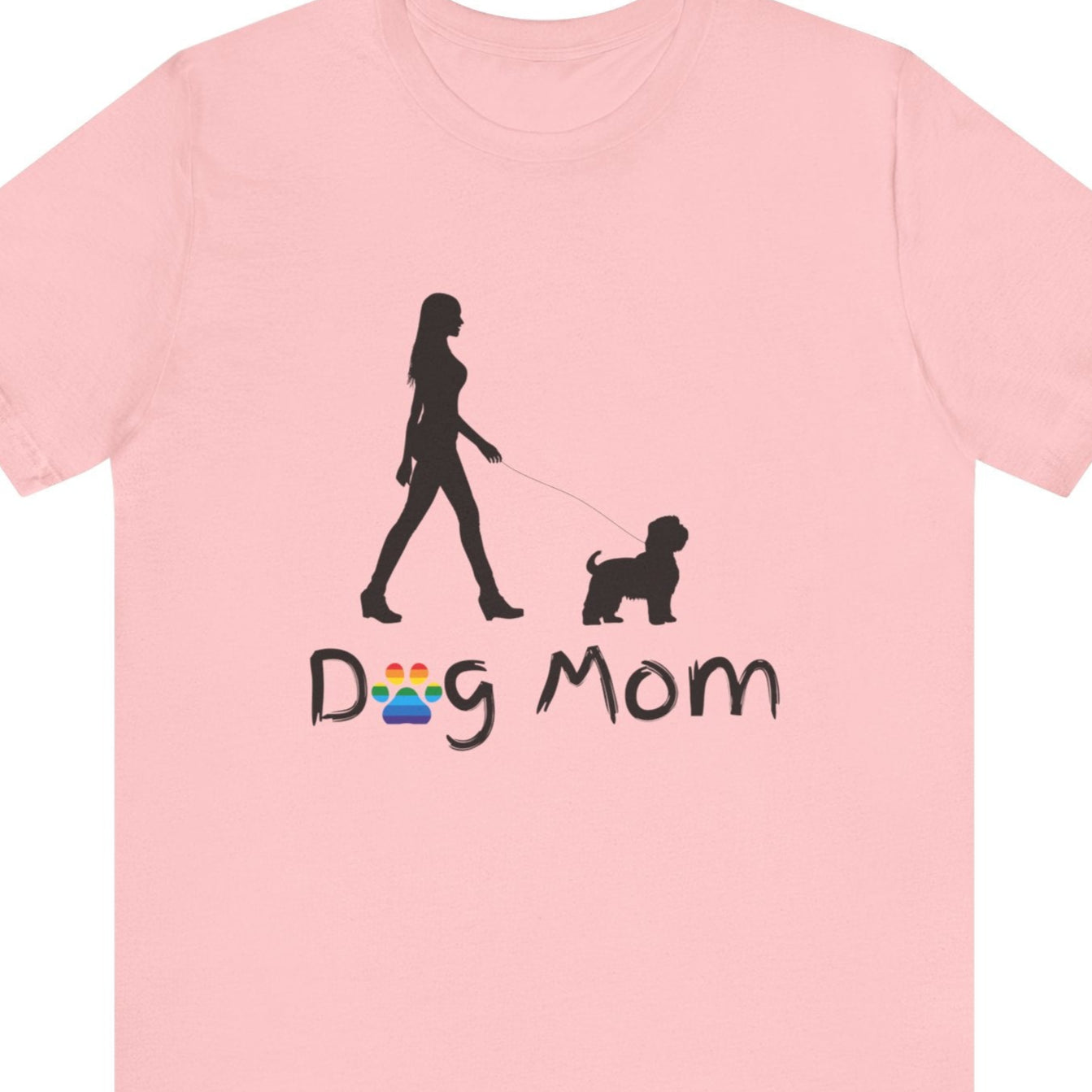 Gay Pride pink t-shirt that says “Dog Mom” with a rainbow paw as the “O” and a silhouette of a lesbian walking her small dog – Designed by Queer Energy