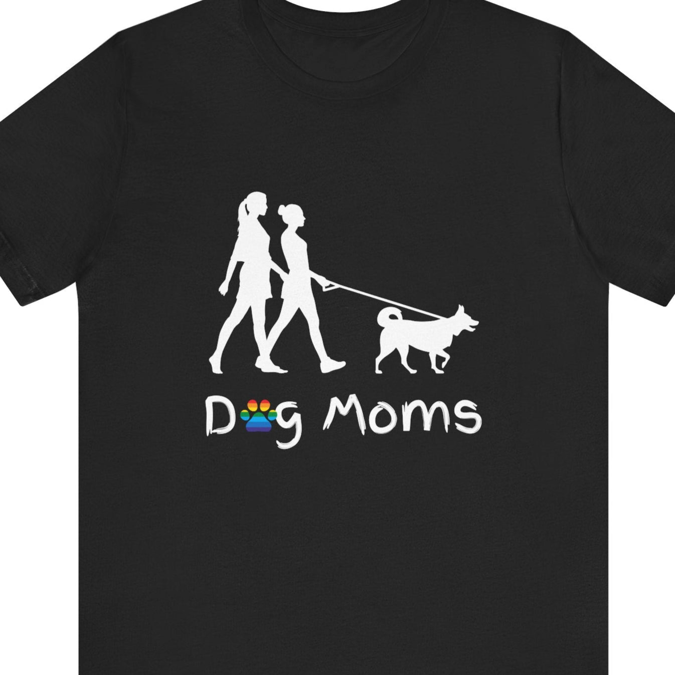 Black LGBTQ Pride tee that says “Dog Moms” with a rainbow paw print and a silhouette of two lesbians walking a dog – Designed by Queer Energy