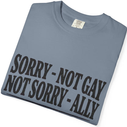 Folded Gay pride tee featuring Sorry Not Gay Not Sorry Ally text with Love Is Love rainbow and transgender pride accents by Queer Energy.