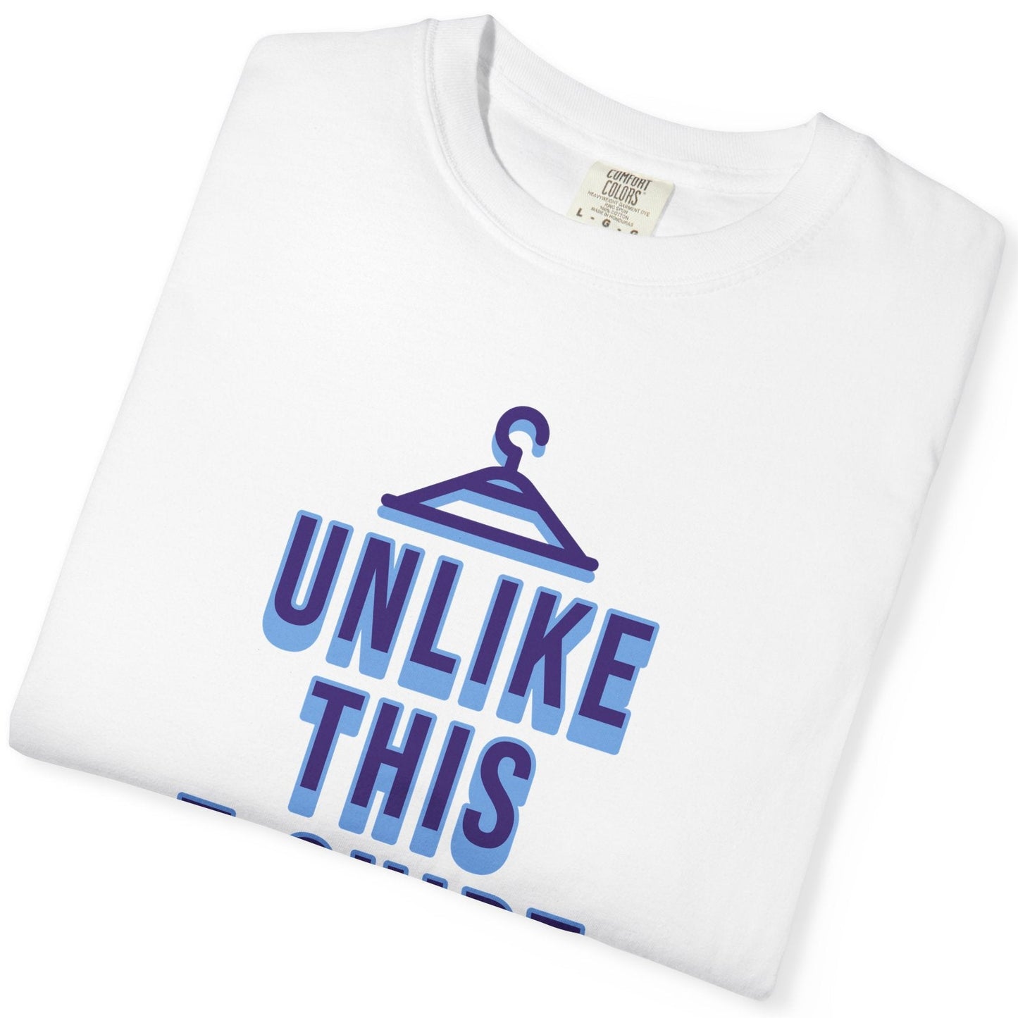 Funny gay pride folded white tee featuring "Unlike This T-Shirt, I Am Hung" text with male symbols, designed by Queer Energy.