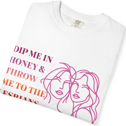 Gay pride t-shirt featuring Dip Me in Honey & Throw Me to the Lesbians design in lesbian flag colors with line drawing of two lesbians by Queer Energy. Folded white sapphic tee