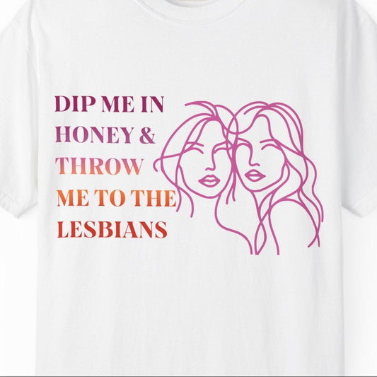 Gay pride t-shirt featuring Dip Me in Honey & Throw Me to the Lesbians design in lesbian flag colors with line drawing of two lesbians by Queer Energy in white