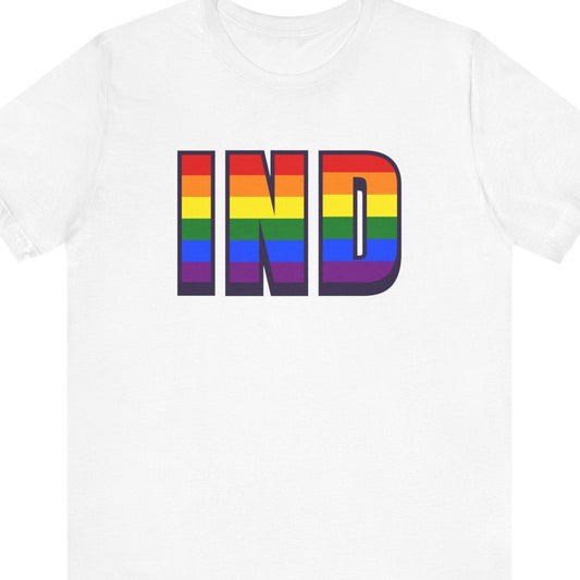 White T-shirt that says IND | Indianapolis International Airport | Pride tee with the text in Pride rainbow color
