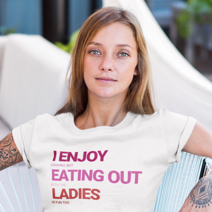 mockup of a sexy blonde lesbian wearing a white tee that say I ENJOY cooking, but eating out with the LADIES is fun too | Funny Lesbian Tee by Queer Energy