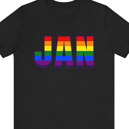 Black T-shirt that says JAN | Jackson-Evers International Airport with the text in LGBTQ rainbow colors