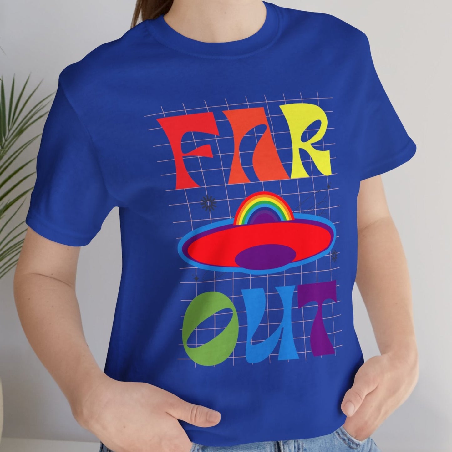 Mockup of Lesbian wearing a Blue T-shirt with “Far OUT” in bold retro-style LGBTQ rainbow colors – Designed by Queer Energy