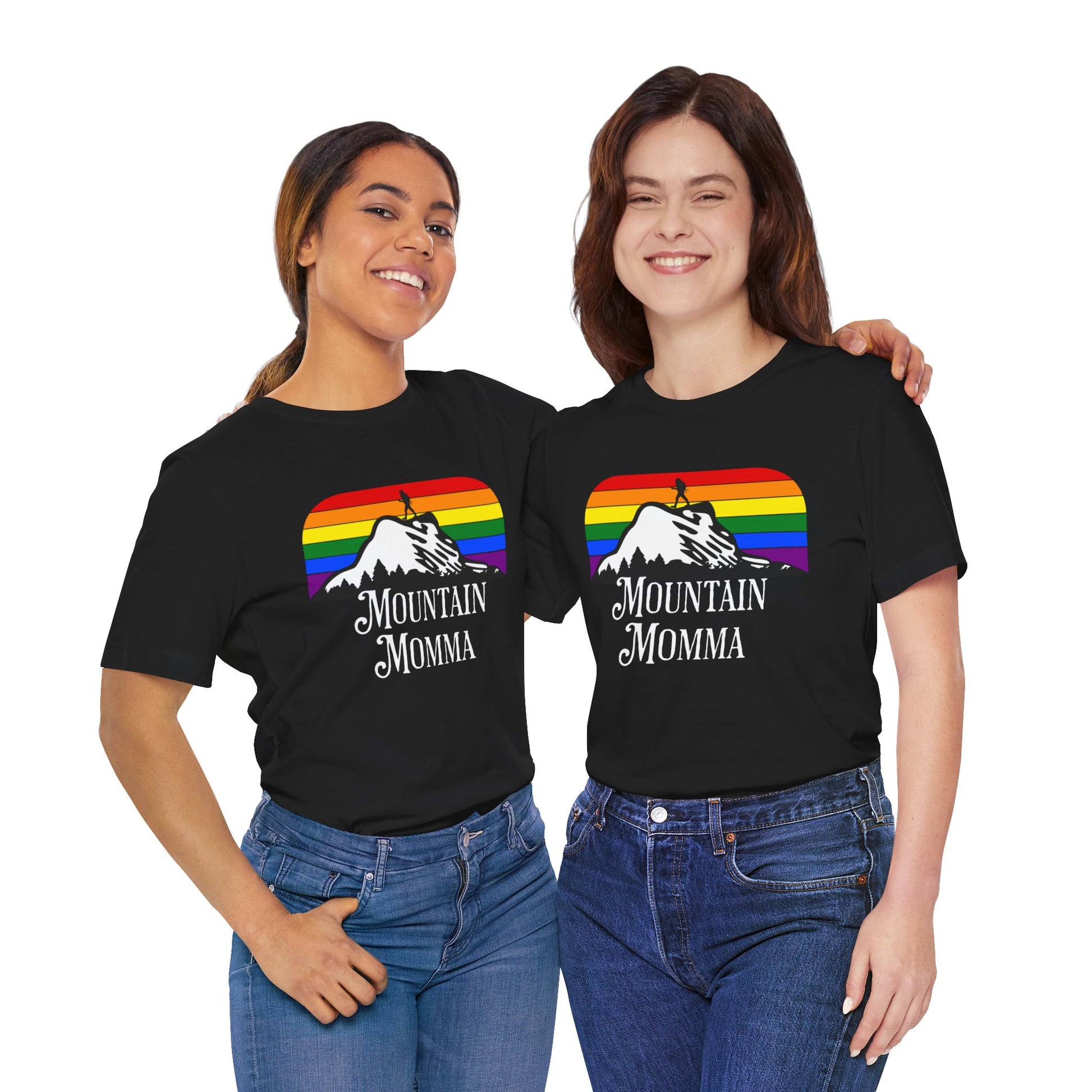 Mockup of two lesbians wearing a black Lesbian Pride tee that says Mountain Momma| LGBT Pride tee with a rainbow background designed by Queer Energy 