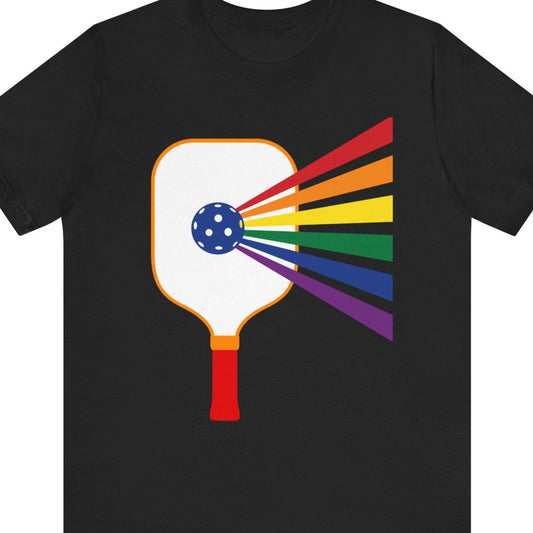 Black Tee with rainbow-colored pickleball paddle design – Designed by Queer Energy