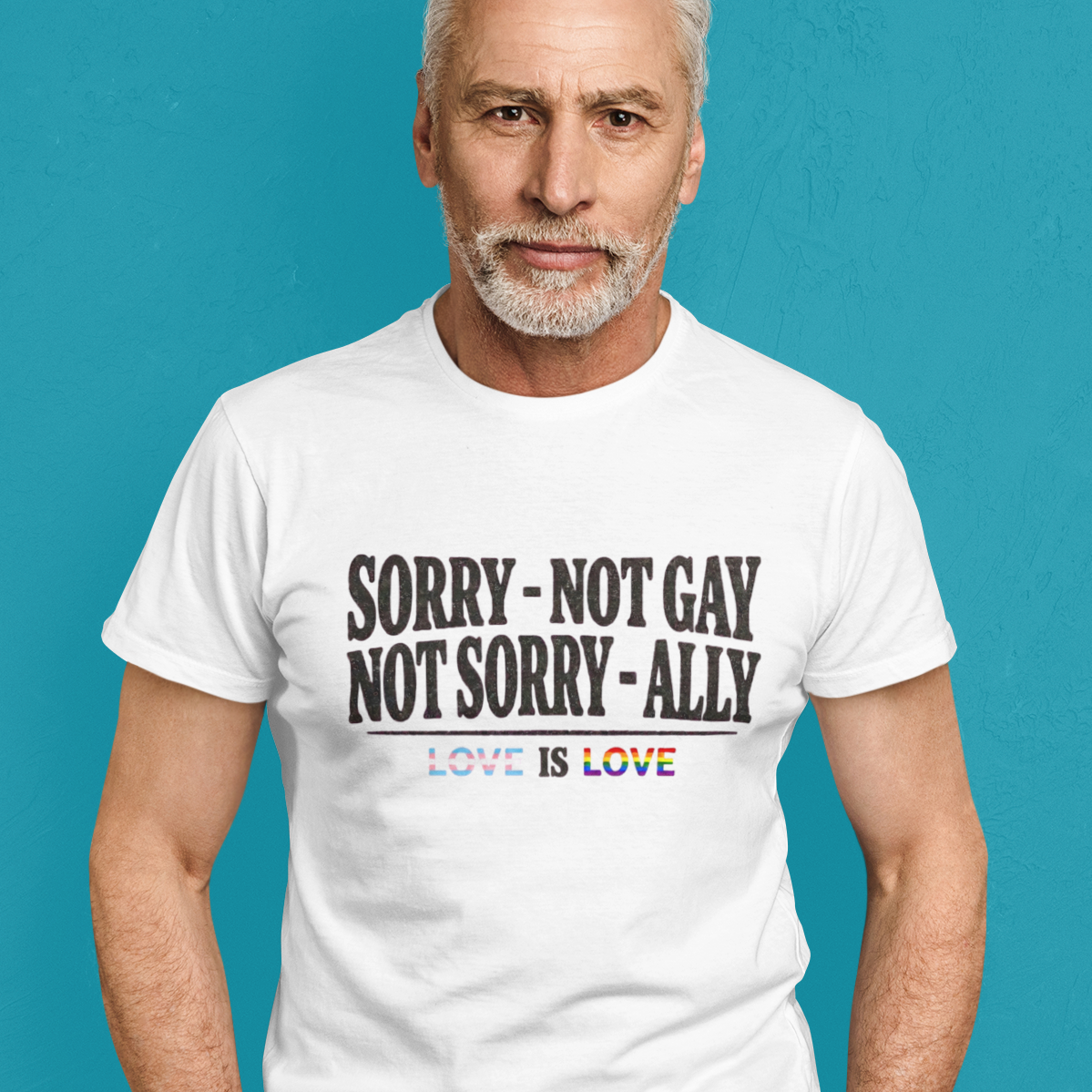 Straight man wearing a Gay pride tee featuring Sorry Not Gay Not Sorry Ally text with Love Is Love with progress flag accents by Queer Energy.