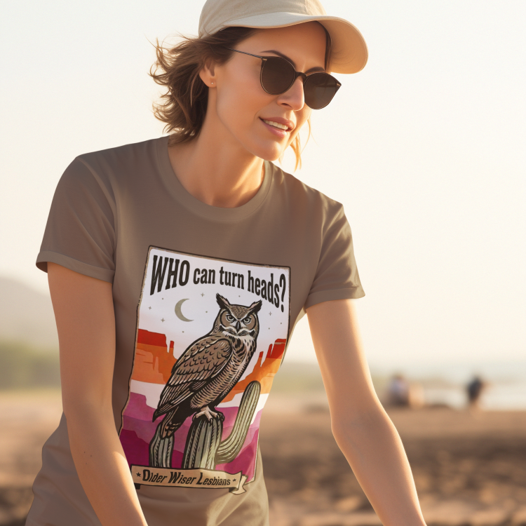Mockup of Lesbian wearing a Gay pride tee featuring an owl with the phrase "WHO Can Turn Heads? Older Wiser Lesbians" in a vintage desert design by Queer Energy.