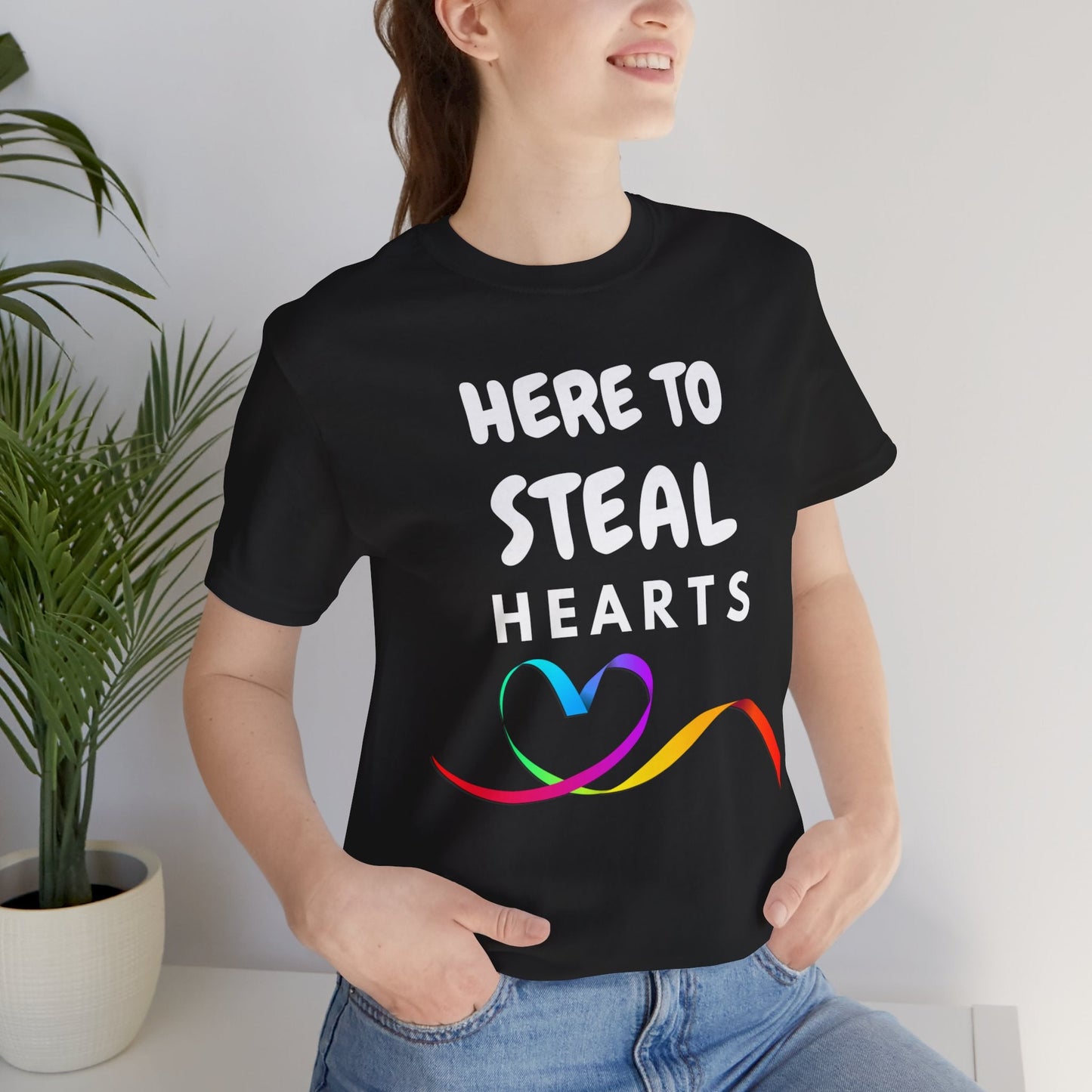 HERE TO STEAL HEARTS | LGBTQ Pride Tee with Rainbow Ribbon Heart - Queer Energy